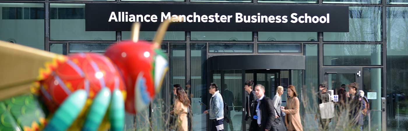 The front of Alliance Manchester Business School with the Beejing sculpture in the foreground